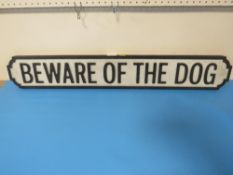 AN ADVERTISING SIGN BEWARE OF THE DOG