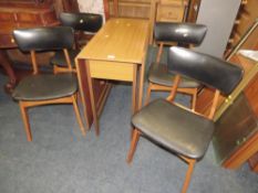 A MID CENTURY 'SCHREIBER' STYLE DROPLEAF TABLE AND FOUR CHAIRS