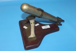 MILITARY INTEREST , BRASS TRENCH ART MODEL OF A TORPEDO, MOUNTED ON A DISPLAY BRACKET L. 26CM