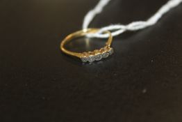A ILLUSION SET FIVE STONE DIAMOND RING INDISTINCTLY MARKED YELLOW METAL POSSIBLY STAMPED C18 approx