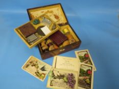 A VICTORIAN WORKBOX CONTAINING COLLECTABLE'S TO INCLUDE A SPALDING WHISTLE
