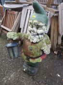 A LARGE CONCRETE STATUE LIGHT OF A GARDEN GNOME