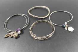 A SELECTION OF SILVER AND WHITE METAL BANGLES