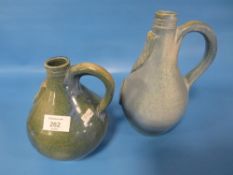 TWO STUDIO POTTERY BELLARMINE STYLE JUGS THE TALLEST 23.5 CM