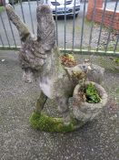 A CONCRETE PLANTER STATUE DEPICTING A DONKEY