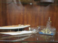 A VINTAGE MODEL OF A YACHT ON STAND TOGETHER WITH TWO SHIPS IN A BOTTLE