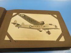 A VINTAGE PHOTO GRAPHICAL POSTCARDS ALBUM FILLED WITH MANY BLACK & WHITE IMAGES OF RAF FIGHTER
