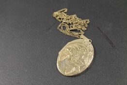A LOCKET AND CHAIN - LOCKET MARKED ROLLED GOLD