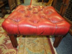 AN OXBLOOD RED LEATHER FOOTSTOOL