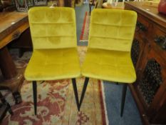 A PAIR OF MODERN MUSTARD UPHOLSTERED DINING CHAIRS