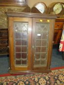 AN EARLY 20TH CENTURY MAHOGANY LEADED/GLAZED CORNER CABINET