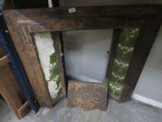 AN ANTIQUE CAST IRON TILED FIRE PLACE