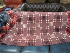 A LARGE WOOL BLANKET WITH TASSEL EDGING