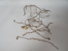 A COLLECTION OF 925 SILVER AND WHITE METAL BRACELETS TO INCLUDE A DOLPHIN EXAMPLE TOGETHER WITH A