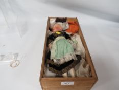 AN ANTIQUE PORCELAIN DOLL WITH ROLLING EYES IN TRADITIONAL DRESS