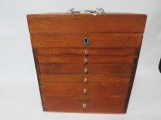 A VINTAGE DENTISTS CABINET WITH VARIOUS INSTRUMENTS