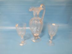 A 19TH CENTURY GLASS EWER JUG, ENGRAVED WITH SHAMROCKS 9 POSSIBLY IRISH ) H 32 CM TOGETHER WITH