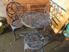 A CAST ALUMINIUM GARDEN PATIO TABLE SET WITH THREE CHAIRS
