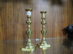 A PAIR OF HEAVY BRASS CANDLESTICKS
