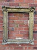 A GILT RECTANGULAR PICTURE FRAME, with raised moulded foliate detail, rebate 65 x 52 cm