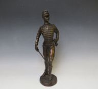 A LATE 19TH / EARLY 20TH CENTURY BRONZE FIGURE STUDY OF A FRENCH ARMY OFFICER WITH SWORD, raised