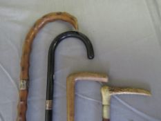 TWO VINTAGE SILVER MOUNTED WALKING STICKS, average L 85 cm, together with two vintage riding