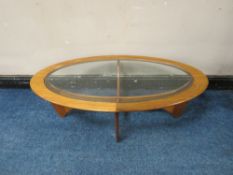A MID CENTURY G-PLAN TEAK AND GLASS OVAL COFFEE TABLE, H 41 cm, W 122 cm