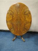 A VICTORIAN WALNUT TILT-TOP LOO TABLE, the quarter veneered top having original snap lock mechanism,