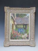 JAMES TOWNSHEND (d.1949). A 20th century impressionist thatched cottage courtyard scene with cat '