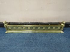 A HEAVY CAST BRASS FIRE FENDER, with panther head details to each end, L 136 cm
