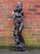 AN UNUSUAL EASTERN HARDWOOD CARVED FIGURE, depicting a semi-clad girl with a baby and a further