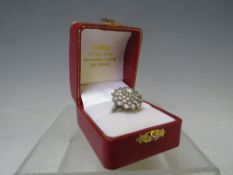 A HALLMARKED 18 CARAT WHITE GOLD DIAMOND CLUSTER RING, set with five rows of brilliant cut