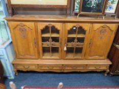 A LARGE FRENCH STYLE OAK GLAZED DRESSER H 145 W 230 CM