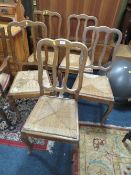 A SET OF FIVE FRENCH STYLE OAK WICKERSEAT CHAIRS