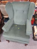 AN UPHOLSTERED ARMCHAIR