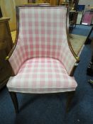 AN UPHOLSTERED ARMCHAIR