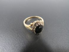 AN 18 CARAT GOLD SAPPHIRE AND DIAMOND RING