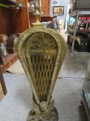 A DECORATIVE BRASS GRIFFIN FIRE GUARD