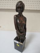 A BRONZE EFFECT SEMI-NUDE FEMALE MODEL