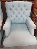 A MODERN UPHOLSTERED ARMCHAIR