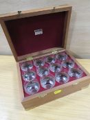 A CASED SET OF TWELVE ENGRAVED TOT GLASSES