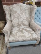 A MODERN UPHOLSTERED ARMCHAIR