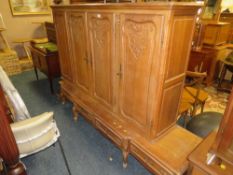 A LARGE FRENCH STYLE OAK CARVED BOOKCASE H 158 W 218 CM