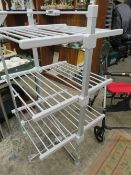 A FOLD AWAY CLOTHES AIRER AND A FOUR WHEEL WALKER