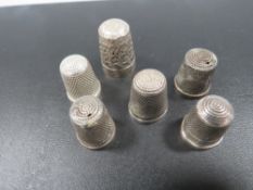 SIX ANTIQUE SILVER THIMBLES INCLUDING CHESTER MARKED EXAMPLES