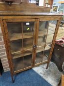 A VINTAGE OAK GLAZED TWO DOOR CABINET W-84 CM