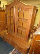 A FRENCH STYLE OAK GLAZED CARVED BOOKCASE/CABINET H 189 CM W 130 CM