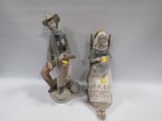 A LARGE LLADRO LADY FIGURINE SEWING SITTING ON A CHAIR WITH A FIGURE OF A MAN A/F