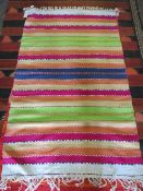 A STRIPED WOOLLEN RUG - 90 X 150 CM