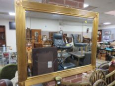 A MODERN GILT RECTANGULAR WALL MIRROR 94 X 119 CM